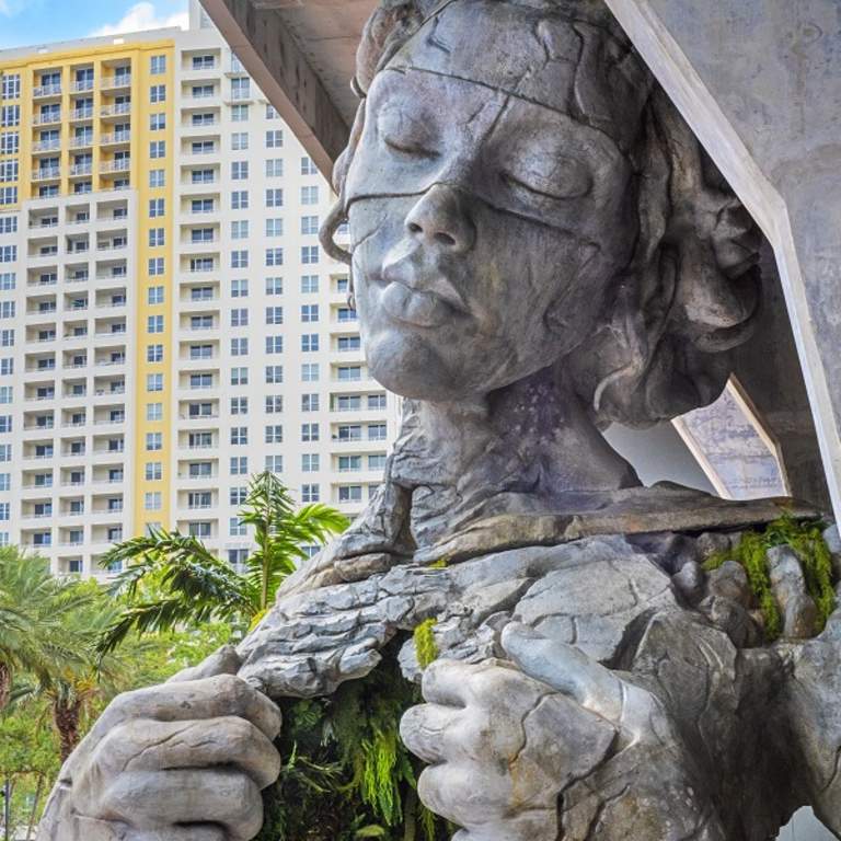 Large statue of woman pulling her chest open