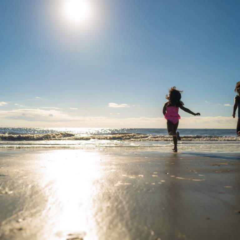 Kids running on the beach