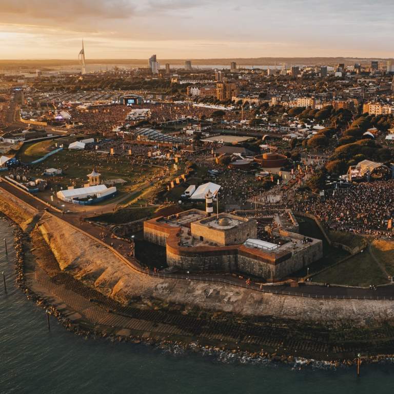 Aerial photograph showing the Victorious Festival site at the golden hour, with Southsea Castle in the foreground