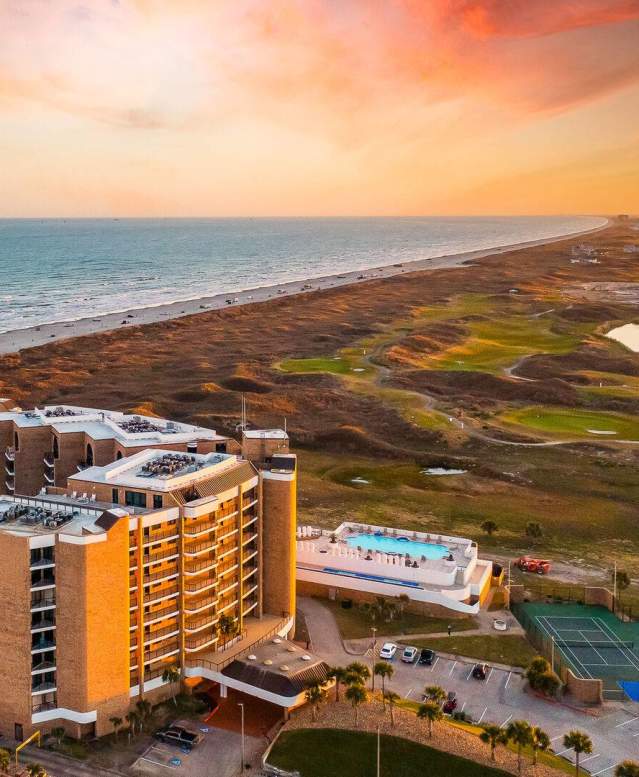 Aerial photo of a beautiful condo building with a beach view