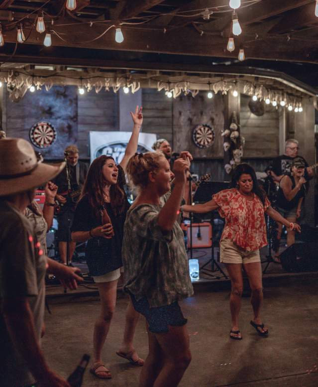 A group of people dance in front of a stage