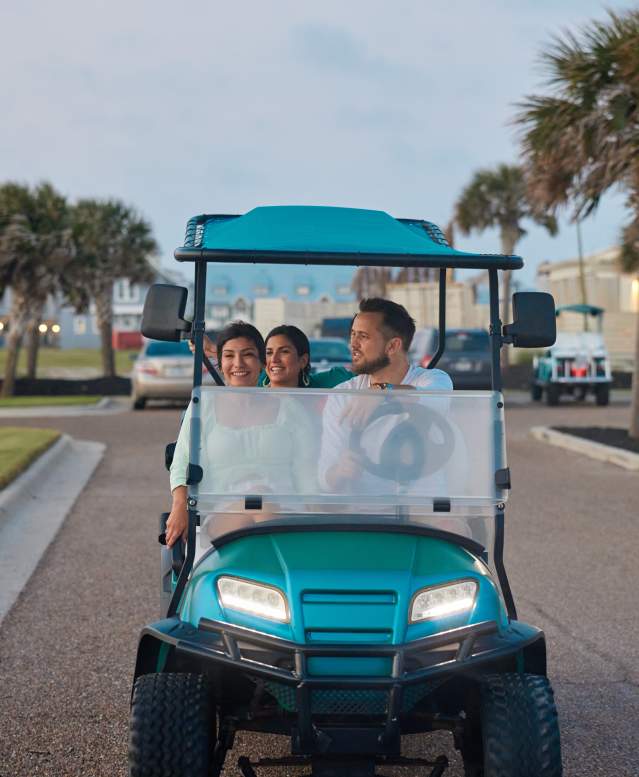 A group of people riding in a golf cart in Port Aransas
