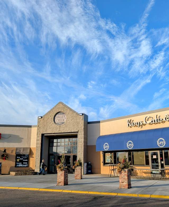 Valley Creek Mall entrance on a sunny morning with light clouds in the sky.