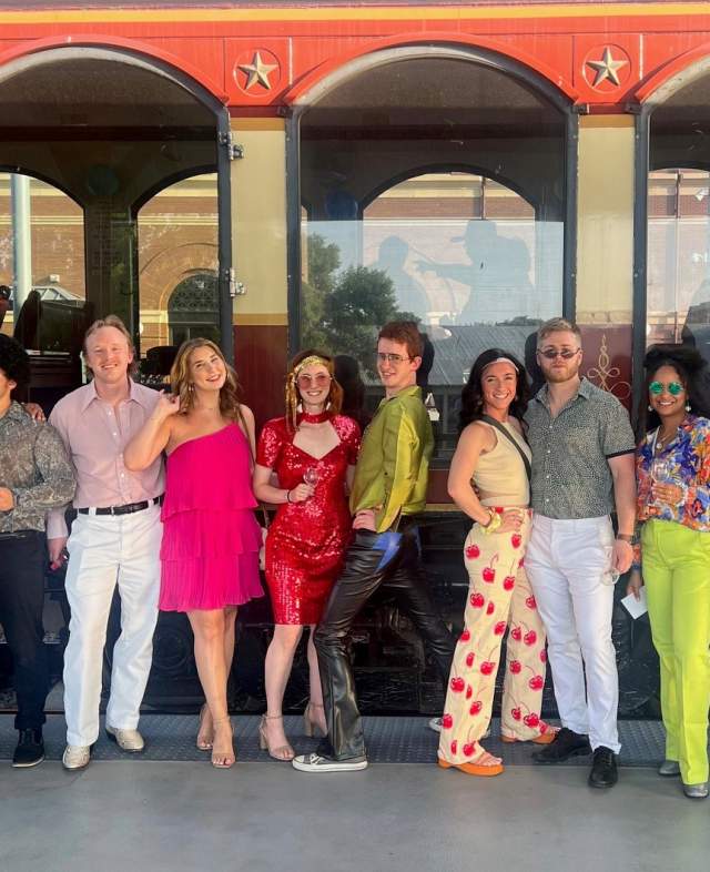People dressed up in disco attires before they ride on the Grapevine Vintage Railroad's Disco Wine Trail