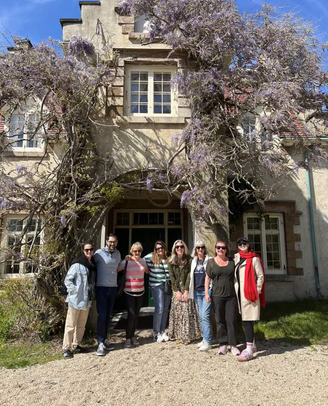 A tour group poses in front of Washington Irving's Sunnyside home.