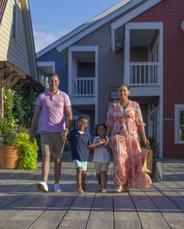 a family taking a stroll at Barefoot Landing
