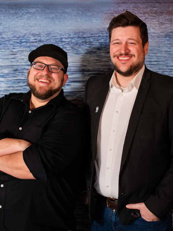 Two men smiling