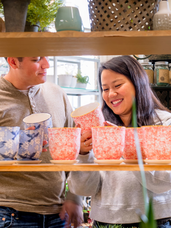 couple looking at colorful plant pots