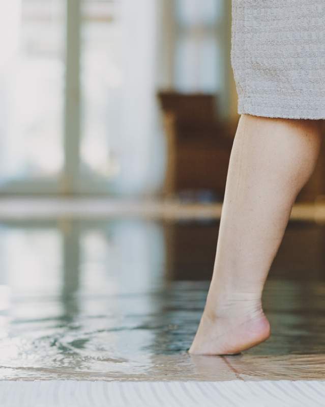 Woman dipping her toe in the pool