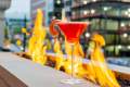 A red cocktail at IDC's patio, positioned in front of an outdoor fire pit in Grand Rapids, MI