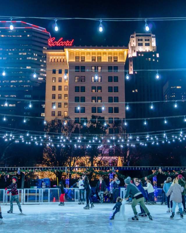 Group ice skating at Downtown in December's Ice Rink