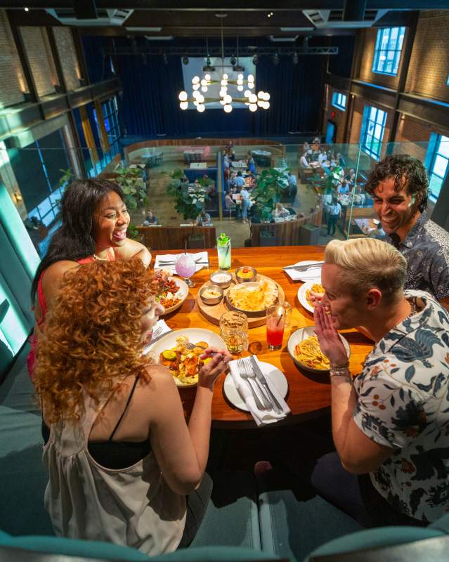 Friends enjoying dinner inside The Jones Assembly in the Film Row District