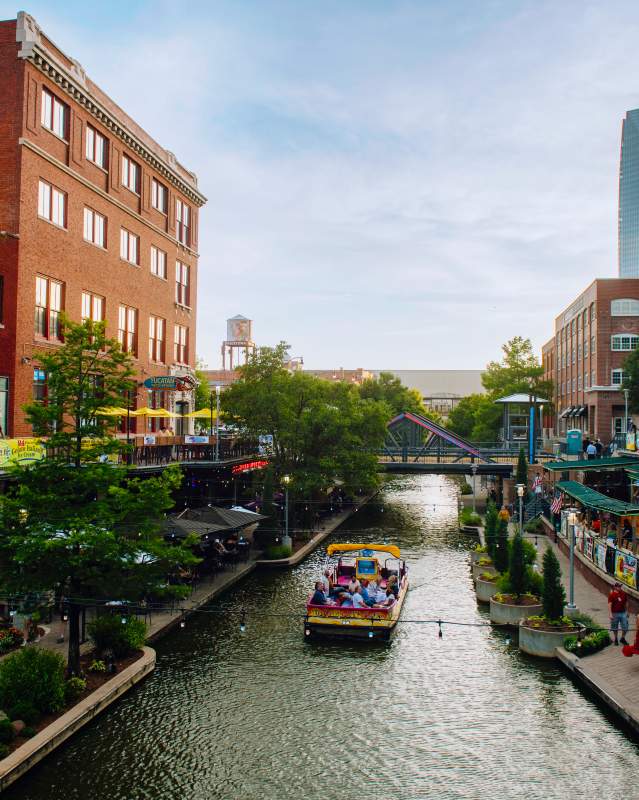 Skyline view of the Bricktown Water Taxi and the canal