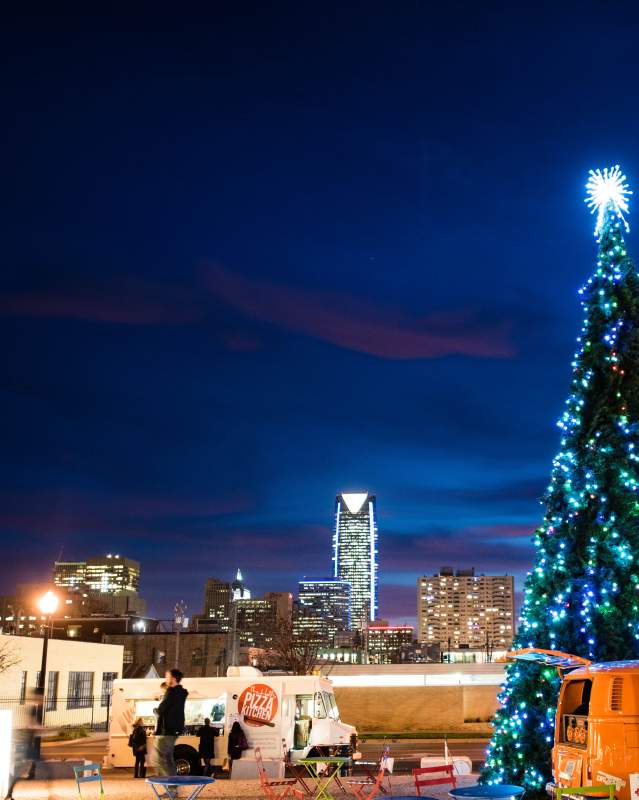 Holiday Pop-Up Shops with Christmas Tree and Skyline in Background.