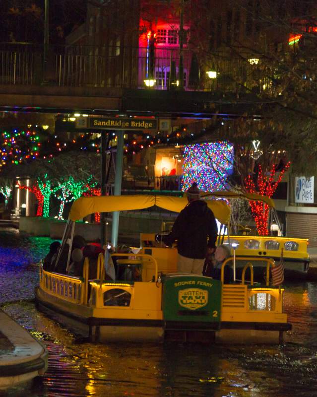 Group seeing lights along the Bricktown Canal in a Bricktown Water Taxi