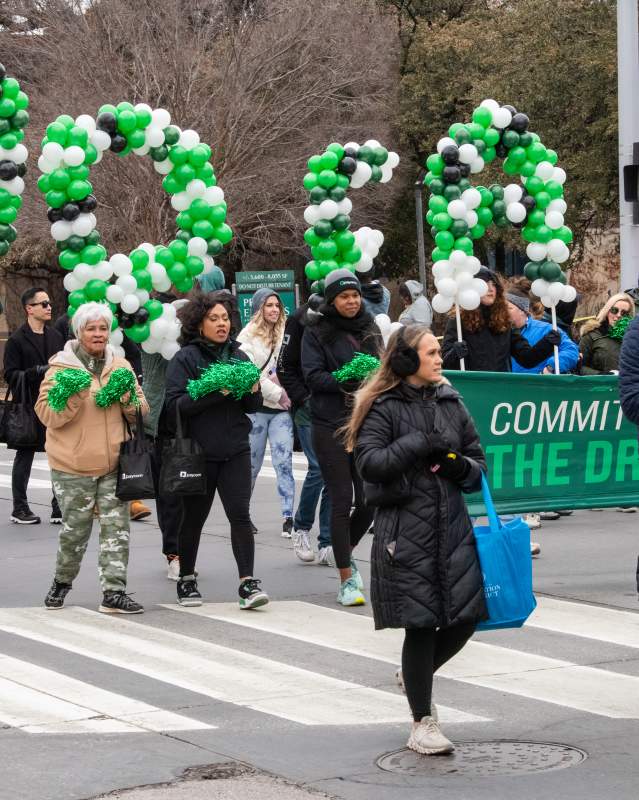 Group of people holding balloons that say "Dream" during annual MLK Jr. Parade