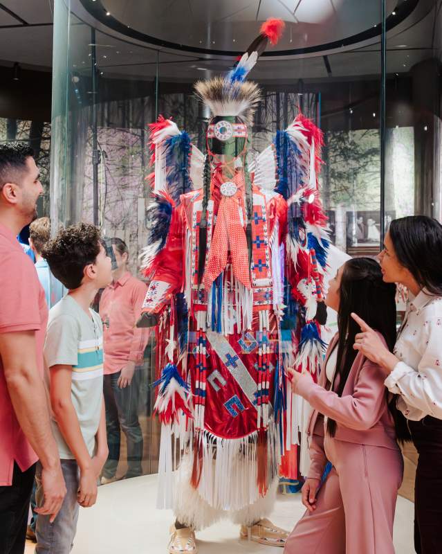 Family looking at Native American regalia at First Americans Museum