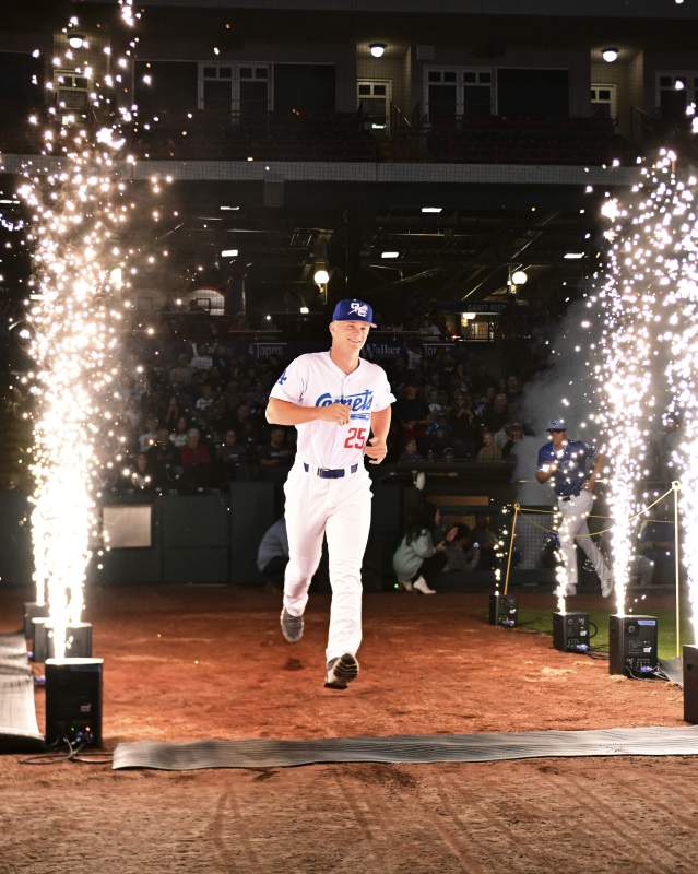 OKC Comets player running through fireworks on the field