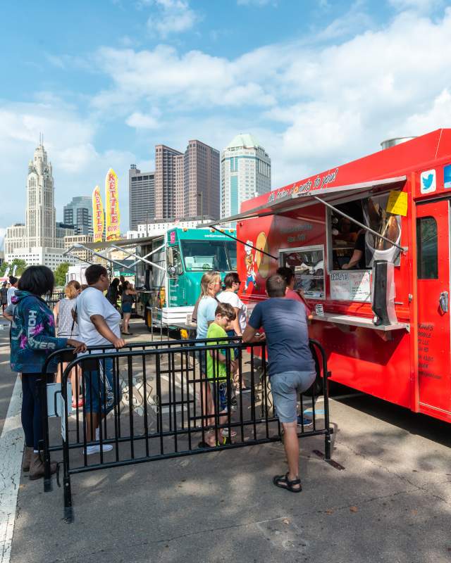 Line of food trucks along the Scioto Mile during Columbus Food Truck Festival