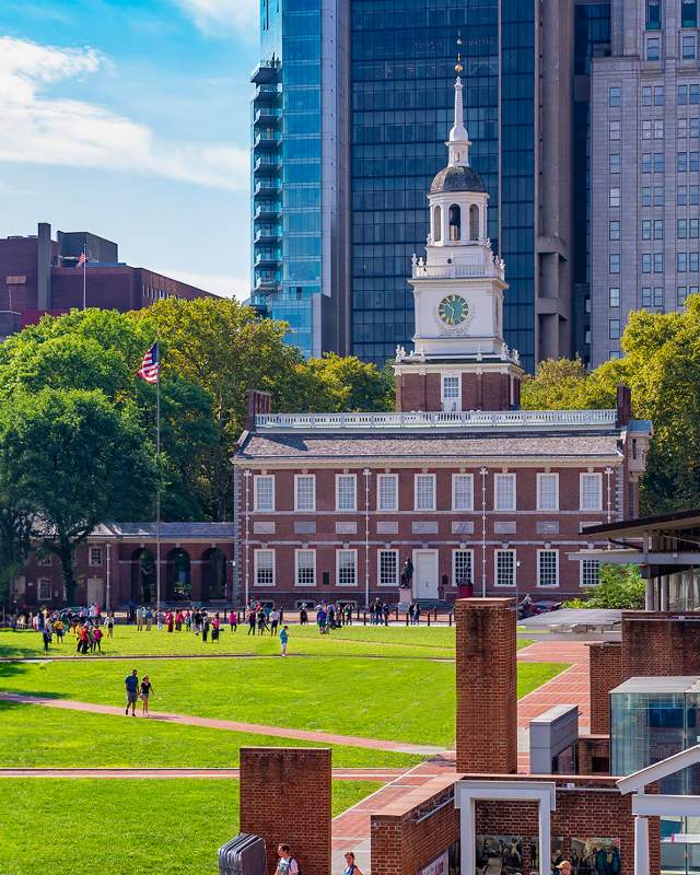 A large clock tower known as Independence Hall in Philadelphia on a sunny day
