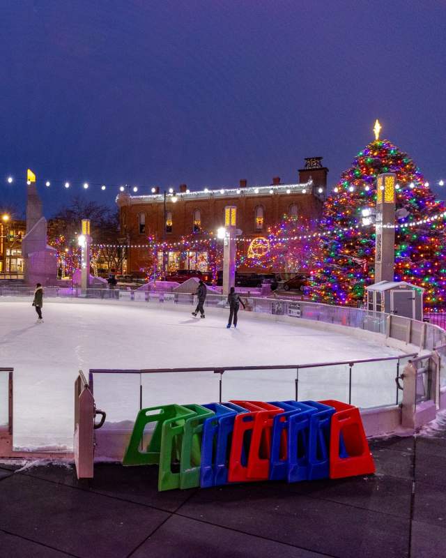 main street square ice rink at night in downtown rapid city, sd surrounded by christmas lights