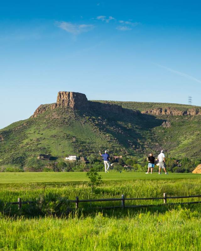 Fossil Trace Golf Club verdant green course with a view of Castle Rock on South Table Mountain