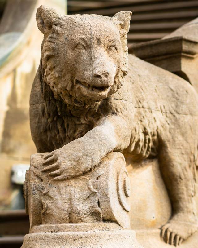 Stone bear cub on the bannister of outside stairs