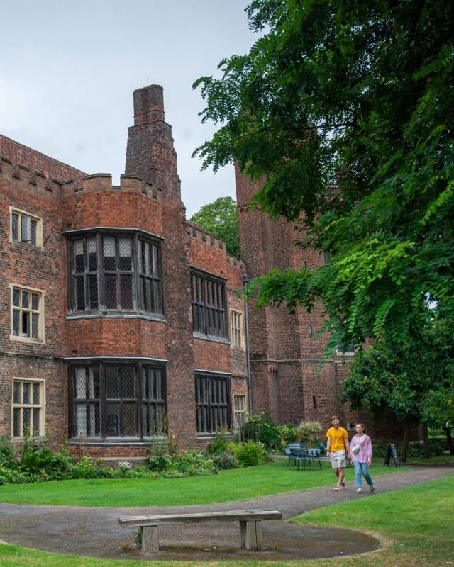 Exterior of Gainsborough old Hall with people walking in the foreground