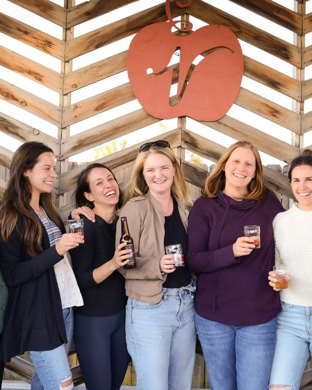 Women with beverages at Virtue Cider's Outdoor Patio