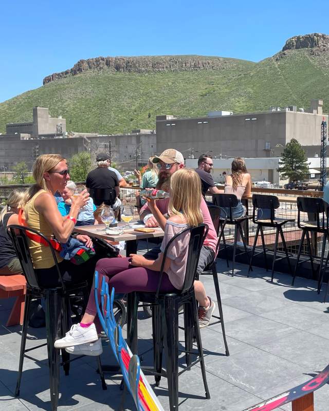 Group dining at Golden Mill Food Hall Overlooking Castle Rock in Golden, CO