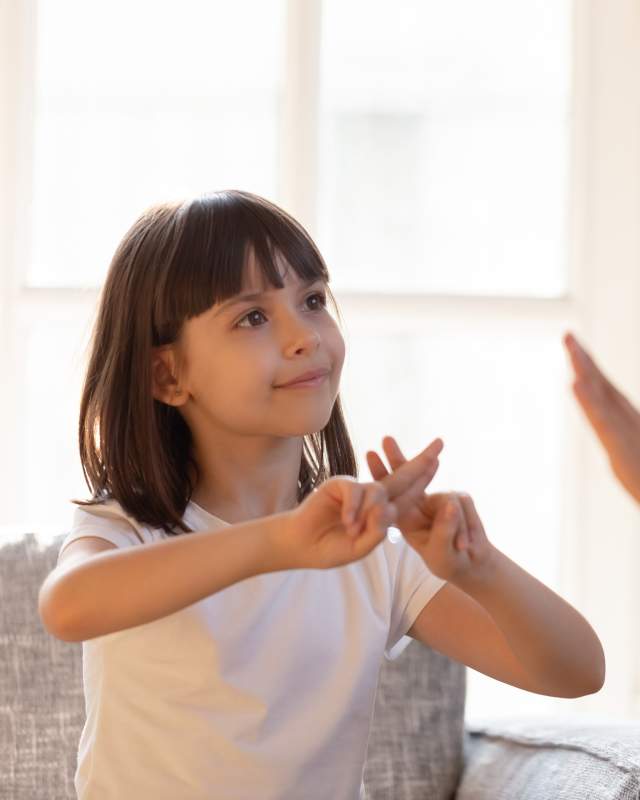 Young girl signing in ASL