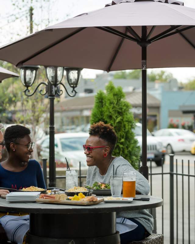 Two moms and their daughter dining on a patio in the Grandview Heights neighborhood of Columbus.