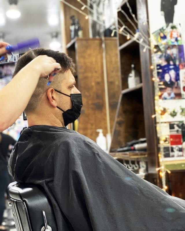 Man in a salon receiving a haircut