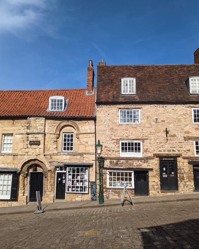 Exterior of Jew's House on Steep Hill in Lincoln with blue sky