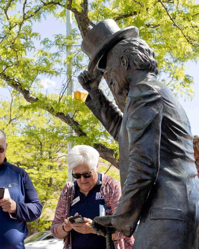 group listening to the city of presidents audio tour in downtown rapid city, sd