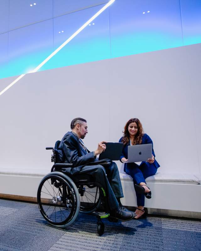 Man in wheelchair talking with woman at Greater Columbus Convention Center