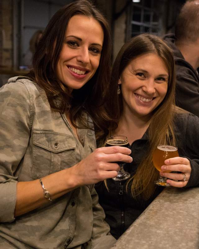 Two friends enjoying a night out at a local brewery in Greater Akron.