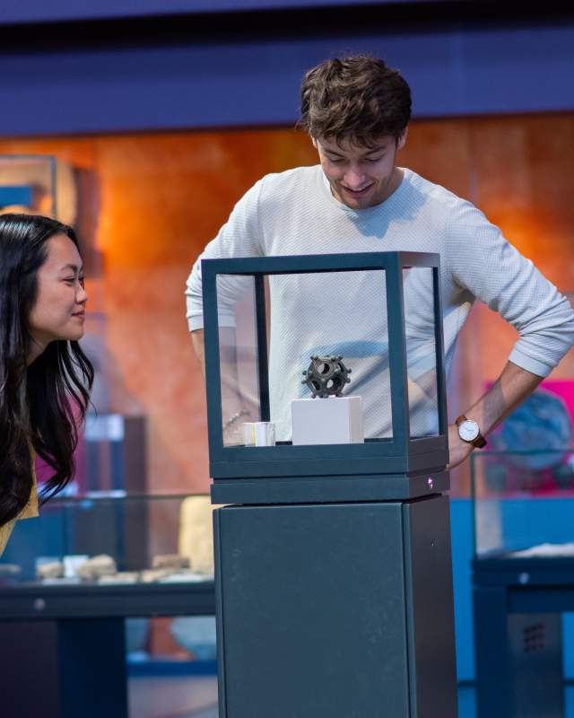 Two people observing the dodecahedron display at at lincoln museum
