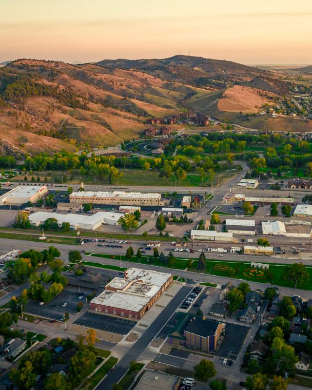 Birds eye view of Rapid City with hill in the background during sunset