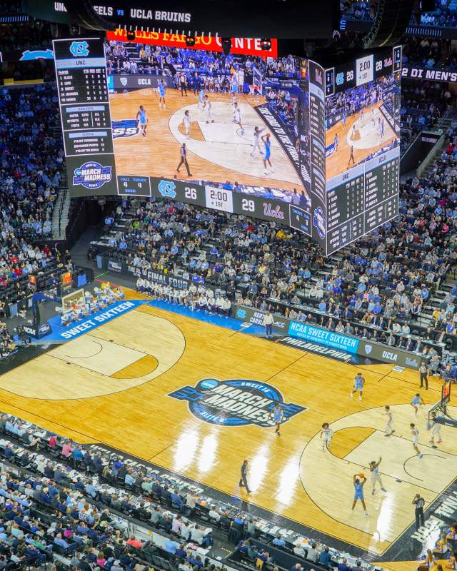 Aerial view of a basketball game being played at Xfinity Mobile Arena in Philadelphia with people in the stands