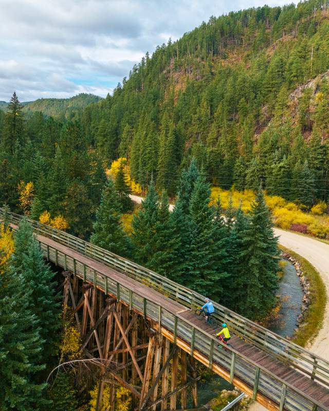 Two bikers riding Mickelson Trail in South Dakota during the fall