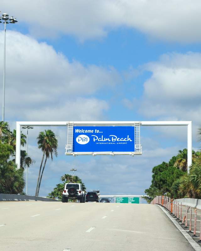 “Welcome to PBI” sign at the entrance of Palm Beach International Airport.