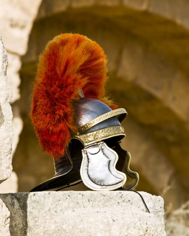 A centurion helmet displayed on roman ruins