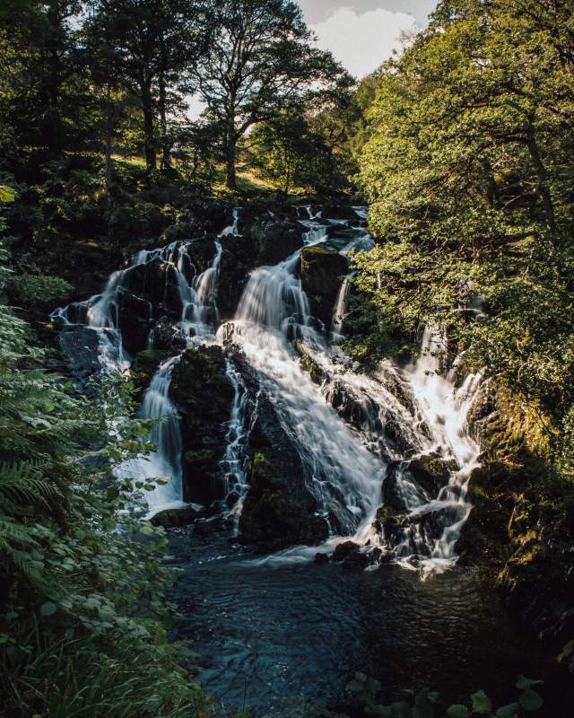 Swallow Falls image with sun shining through the surrounding trees