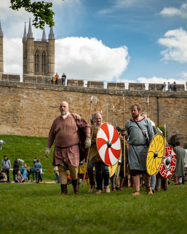 A group of people re-enacting historic battles and life