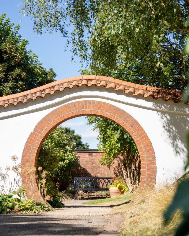 A stone arch in John Dawber Gardens, a community garden in the grounds of The Lawn in Lincoln