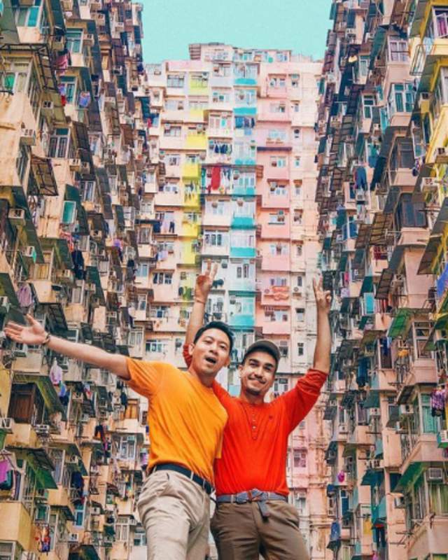 2 men standing in front of an apartment buildings