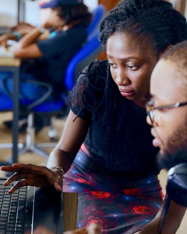 People coding on a laptop