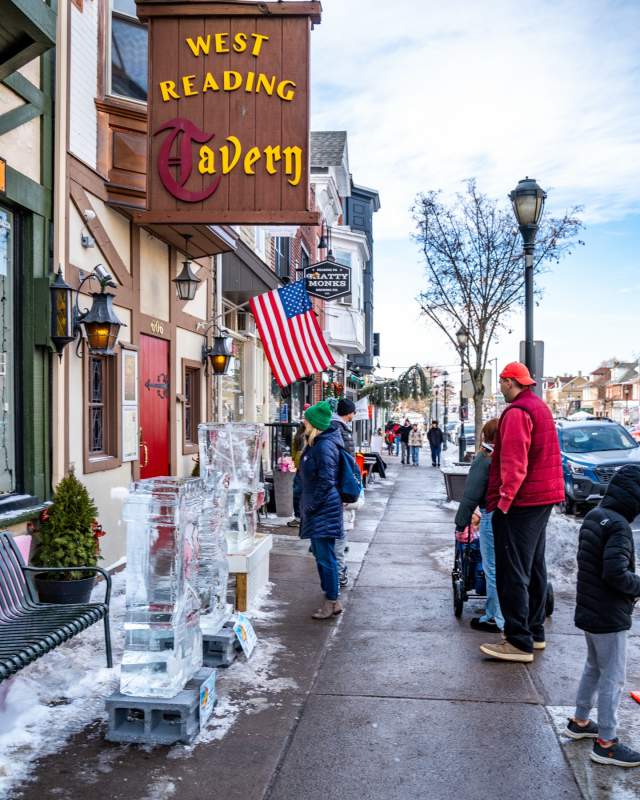 People admiring the ice sculptures on Penn Ave during the ice and spice festival.