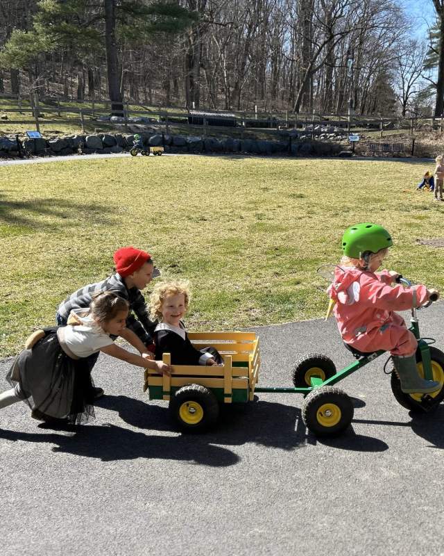 Kids on a tricycle and wagon